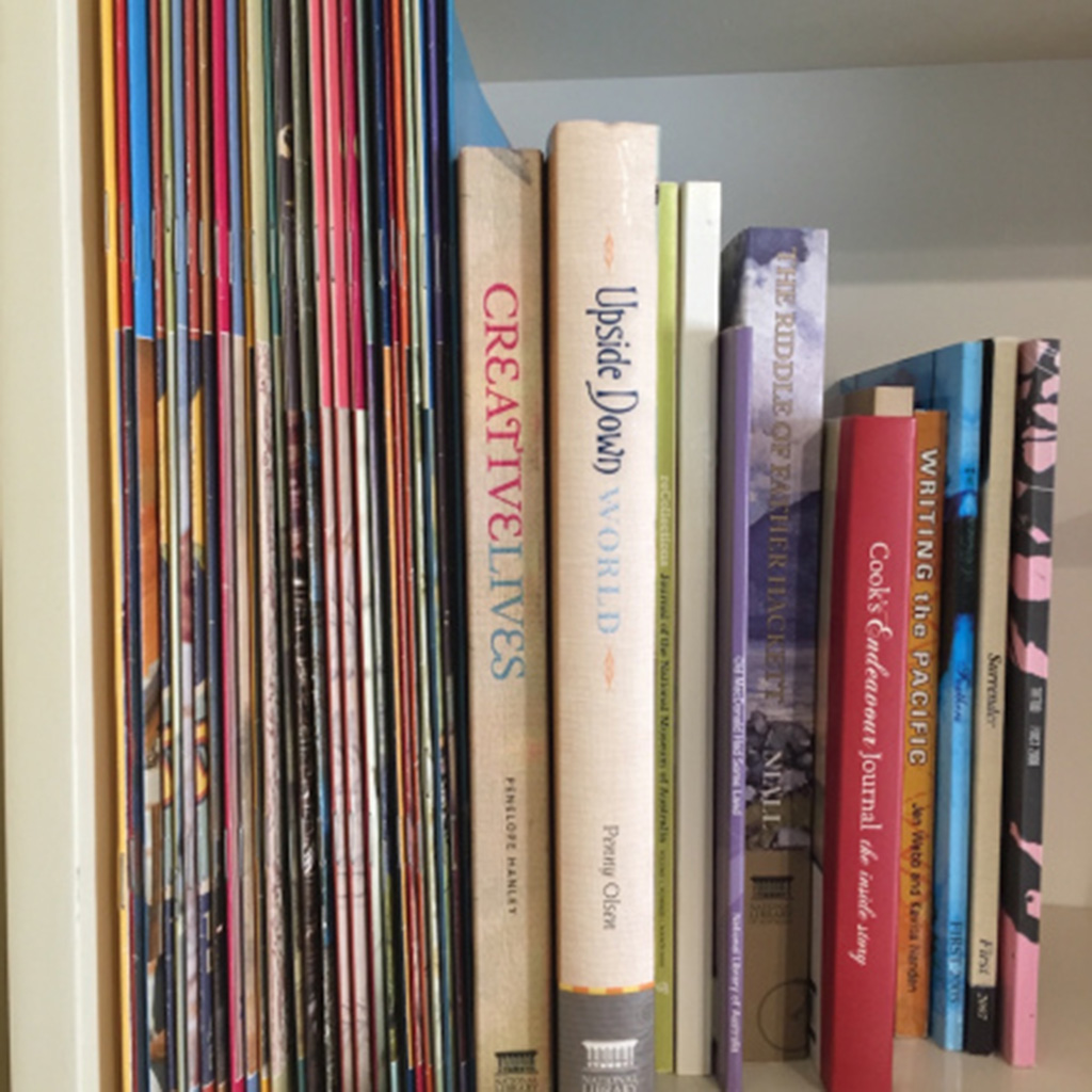 A line of books on a bookshelf, spines visible.