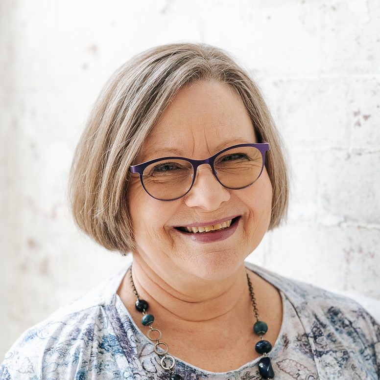 Photo of Lee Ellwood, content editor and writer, wearing thin-framed blue glasses.